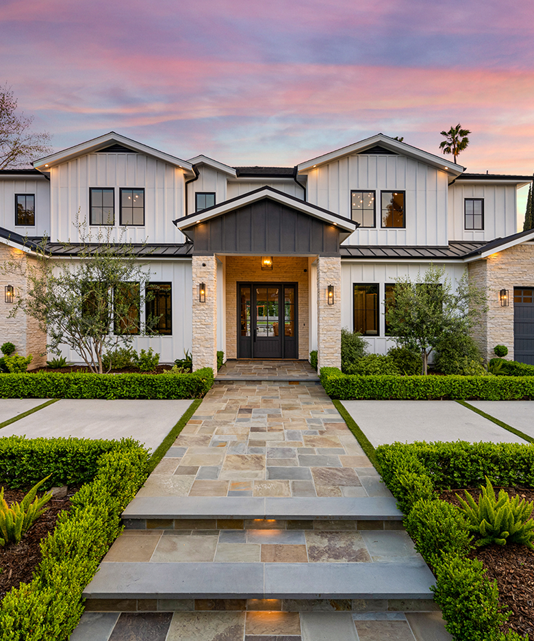 Luxury modern home exterior featuring elegant stone steps leading to a grand entrance.